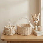 English: Handwoven Rattan Flower Basket with Pearl Handle & Sheer Ribbon Bow, Wicker Floral Arrangement Basket for Wedding, Home Decor & Gift